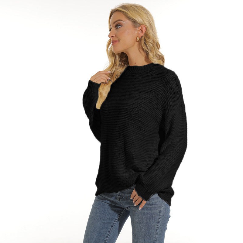 Women’s black knit pullover sweater with crew neck and long sleeves, ribbed hem
