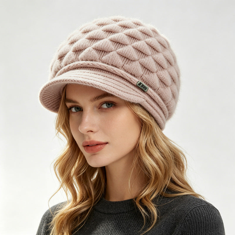 Cream fleece-lined knit beanie with quilted texture and ribbed cuff brim