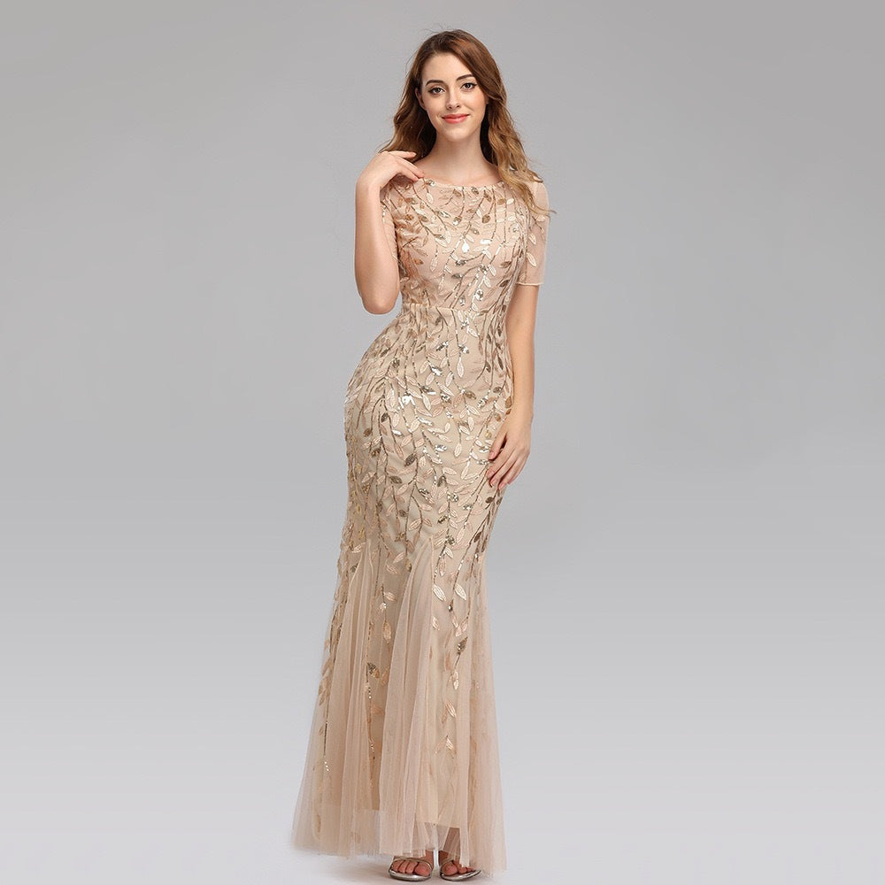 Gold-beige sequin mesh mermaid evening gown with short sleeves and floor-length flare.
