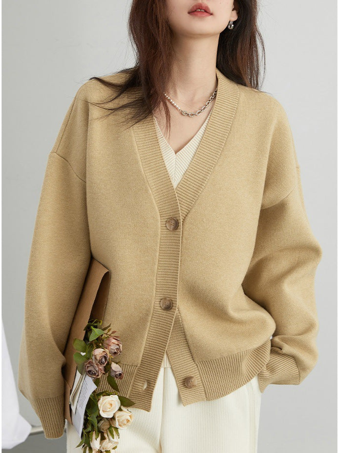 Beige V-neck cardigan sweater with button front, ribbed trim, and long sleeves