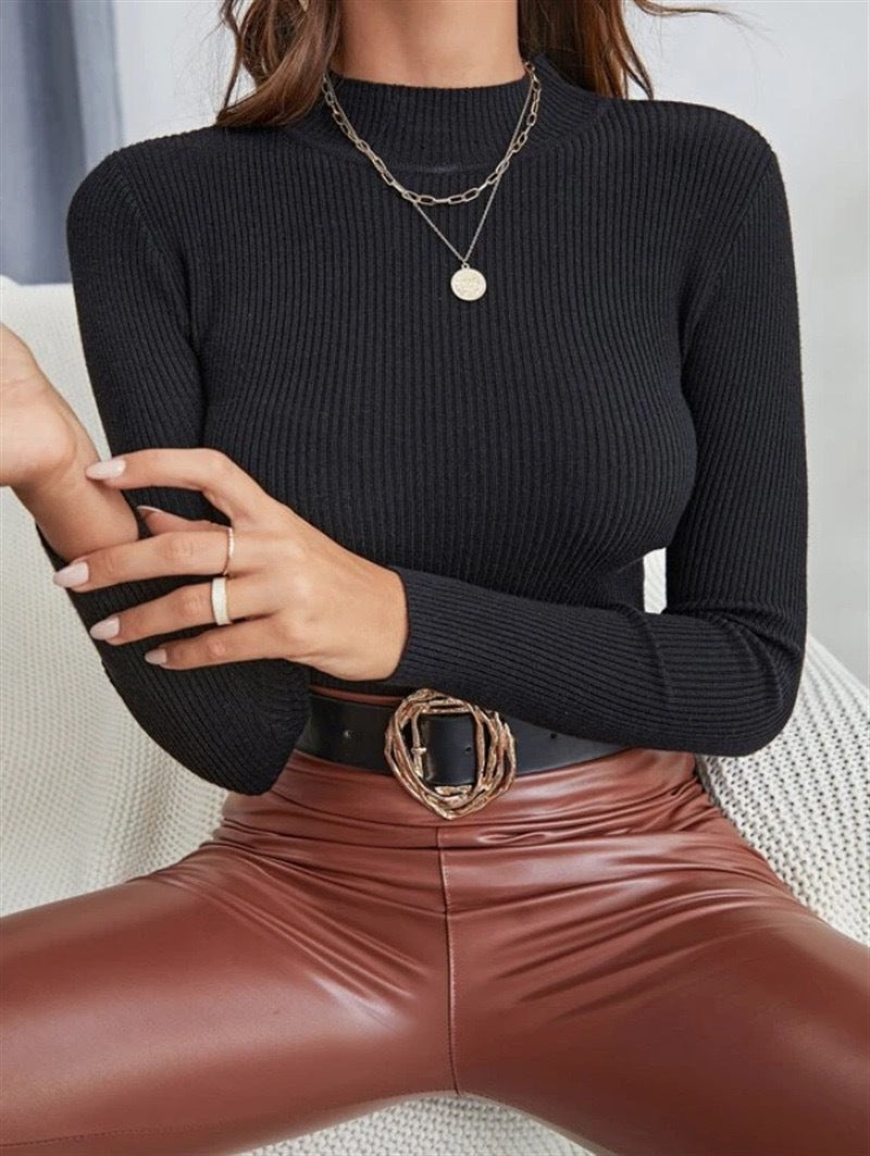 Black mock neck ribbed knit long-sleeve top with fitted silhouette.