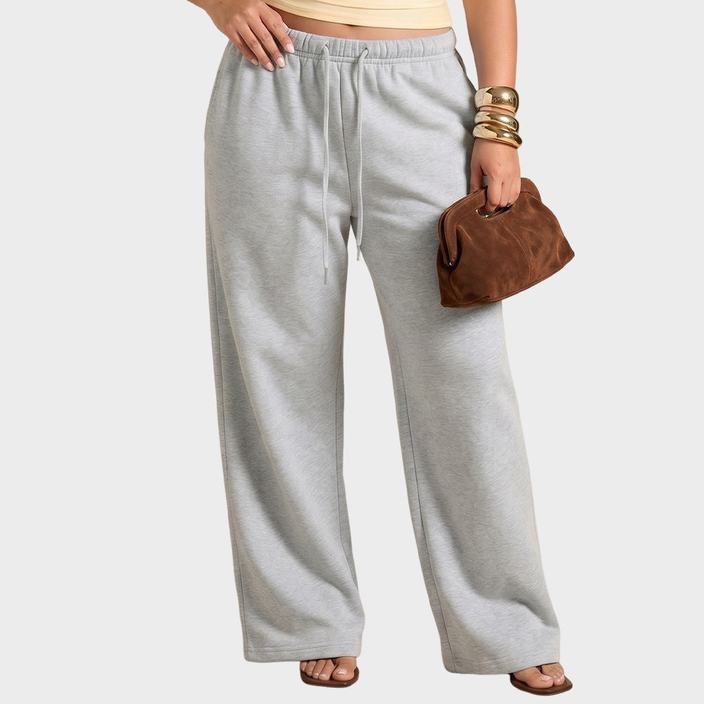 Grey high-waisted wide-leg sweatpants with elastic waistband and drawstring, relaxed fit