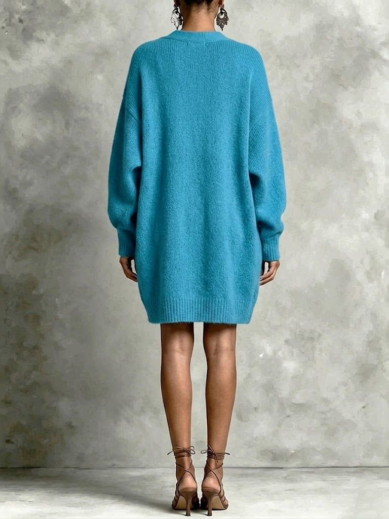 Blue knit cardigan sweater, back view, long sleeves and loose hem