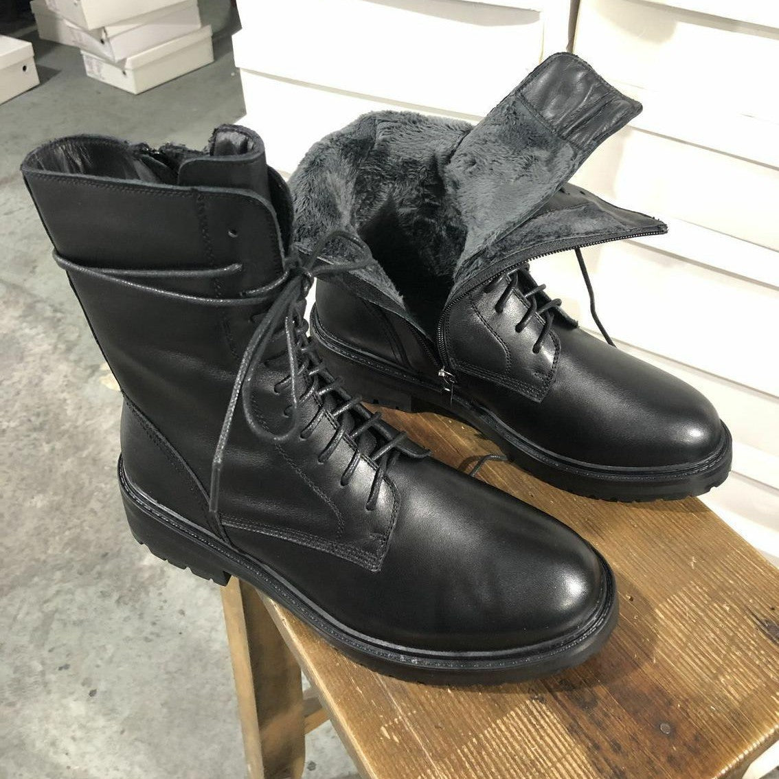 Women’s black lace-up motorcycle boots with side zipper and rugged outsole