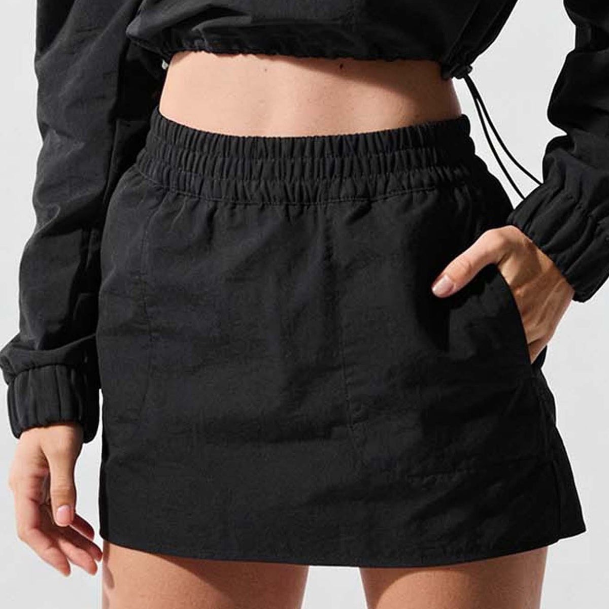 Women’s black mini skirt with elastic waistband, close-up detail