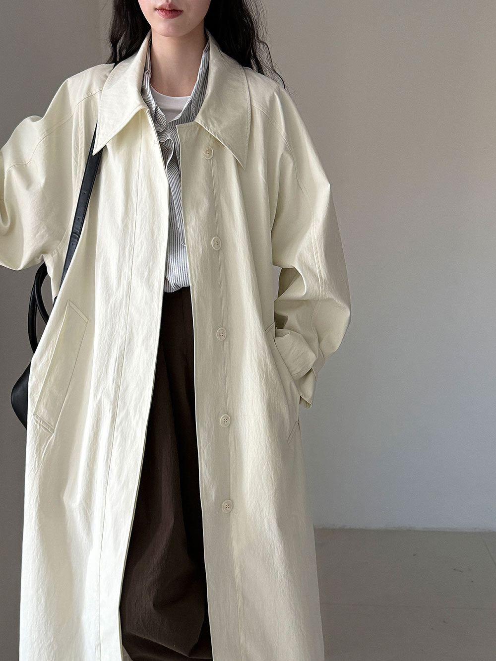 Women’s beige long lapel trench coat with button front and belt tie waist