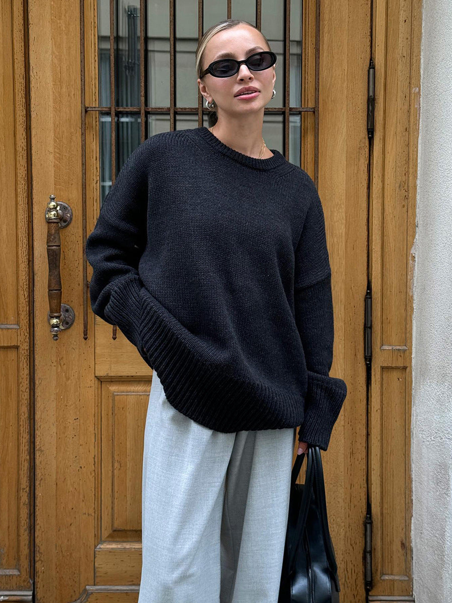Dark navy round-neck knit sweater with long sleeves and ribbed cuffs