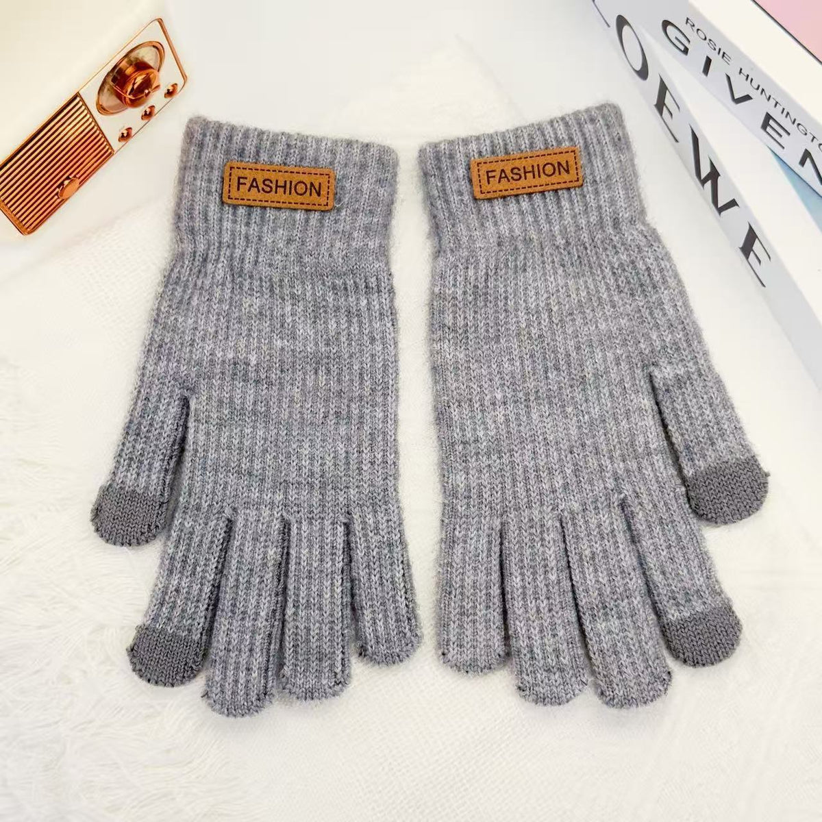 Light gray knitted winter gloves with ribbed cuffs and five finger openings
