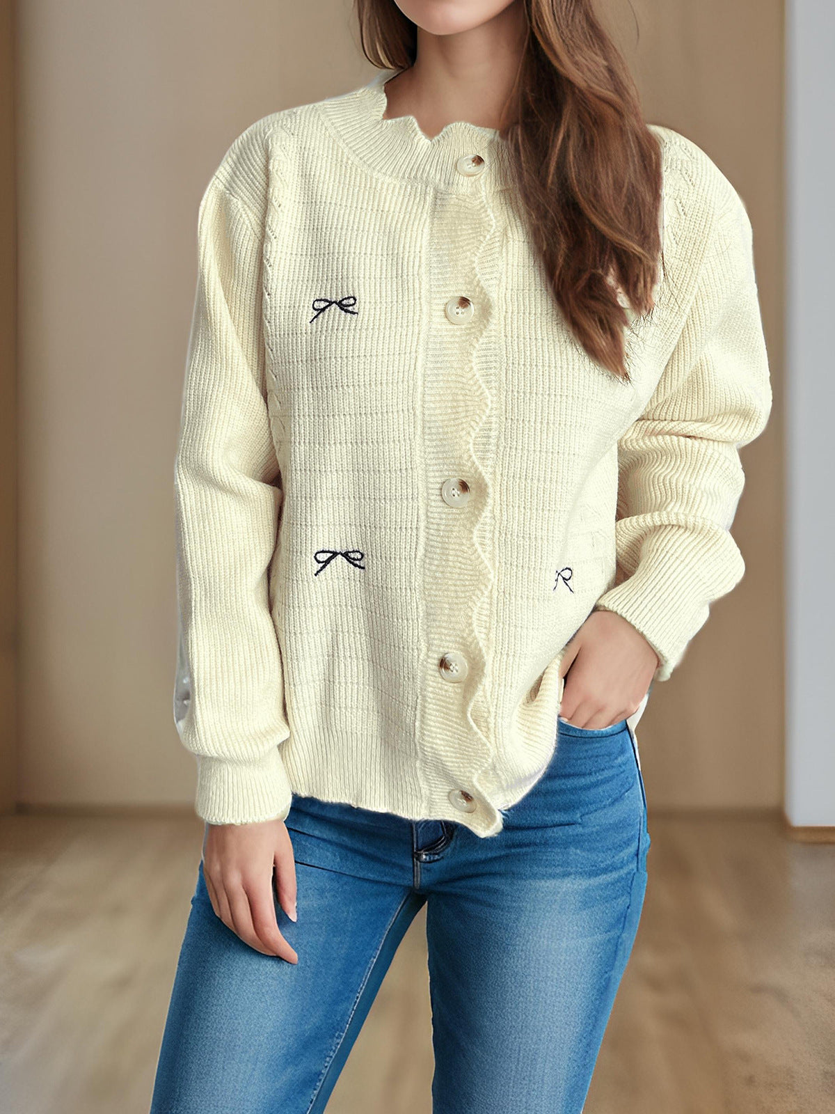 Off-white knit cardigan sweater with bow embroidery, button front, dropped shoulders