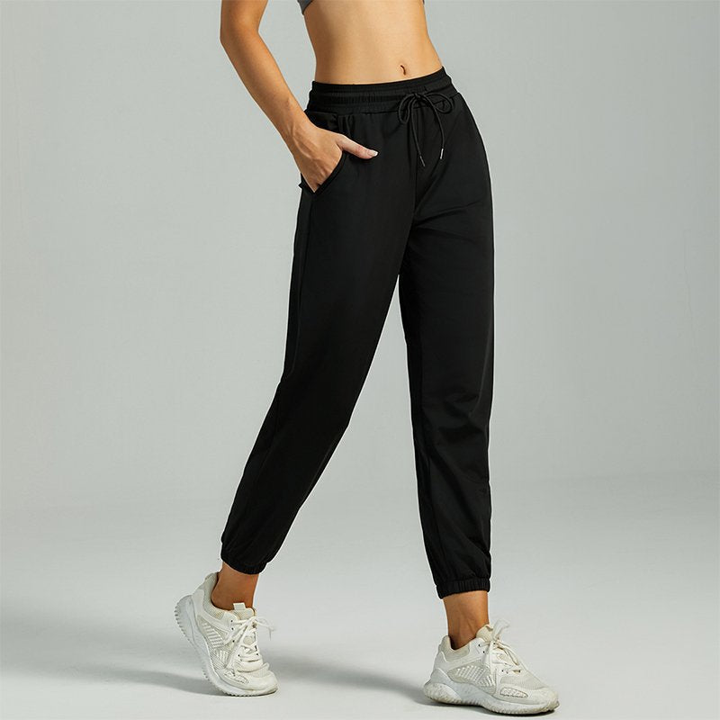 Women's black jogger pants with drawstring waist and cuffed ankle hems