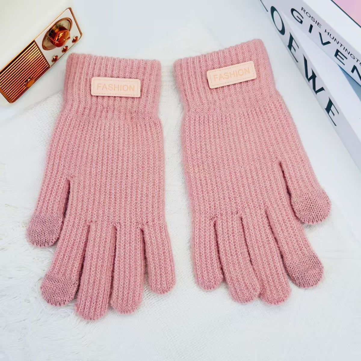 Pink knitted winter gloves with ribbed cuffs and five finger openings