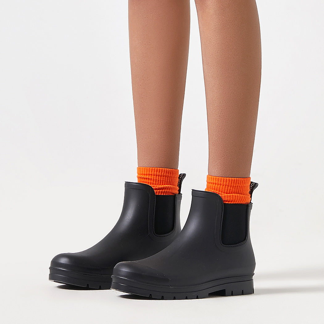 Black short rain boots with pull-on elastic gore and sturdy tread outsole