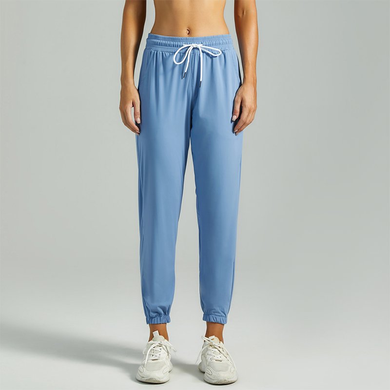 Women's blue jogger pants with drawstring waist and cuffed ankle hems