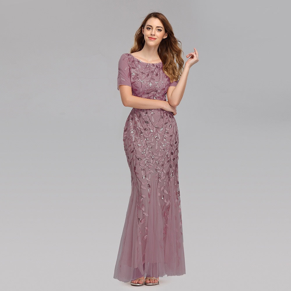 Light purple sequin mesh mermaid evening gown with short sleeves and fitted silhouette.