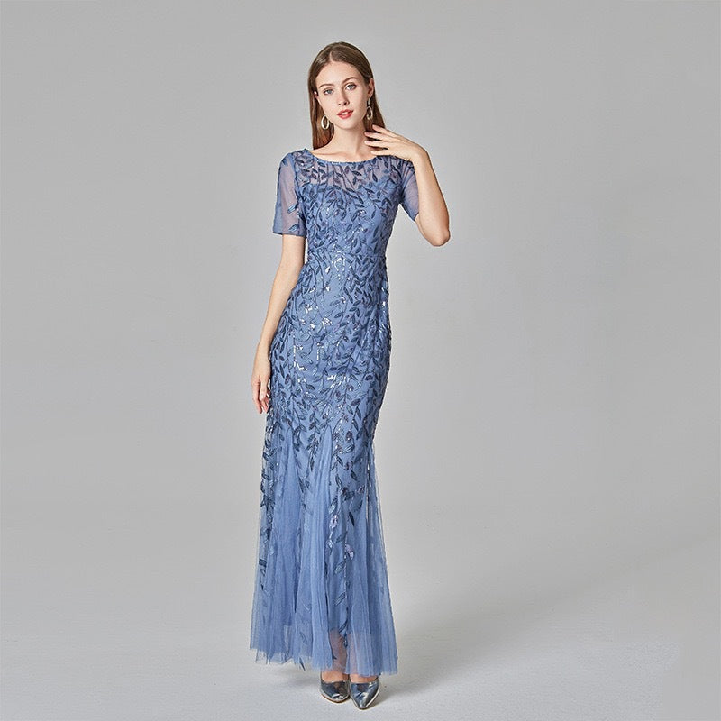 Powder blue sequin mesh mermaid evening gown with short sleeves and flared skirt.