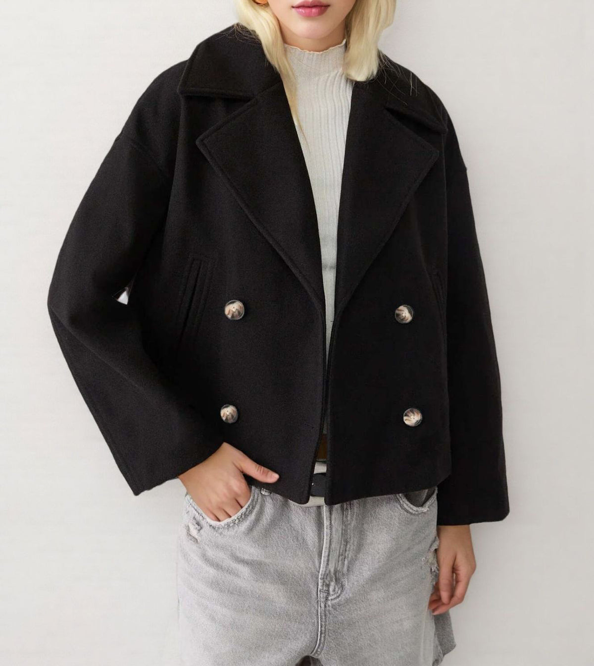 Black double-breasted short wool jacket with notched lapels and silver button accents