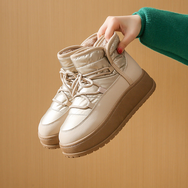 Tan/beige high-top lace-up boots with fleece lining and chunky brown rubber sole