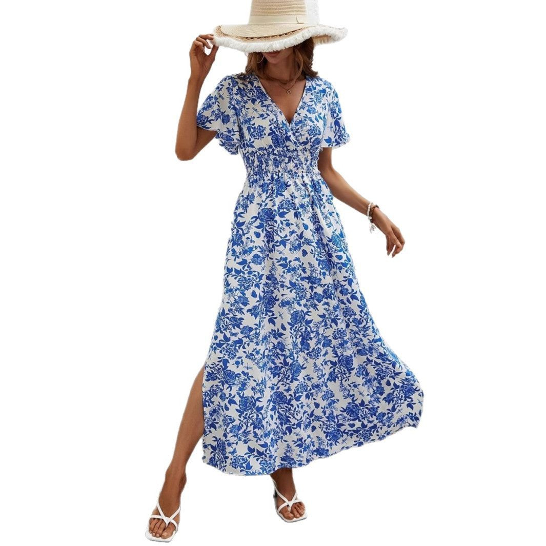 Blue floral maxi dress with V-neck, flutter sleeves, smocked waist, and front slit