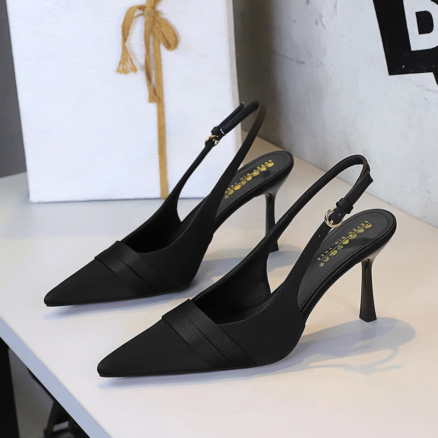 Black satin pointed-toe stiletto slingback heels with cut-out back strap