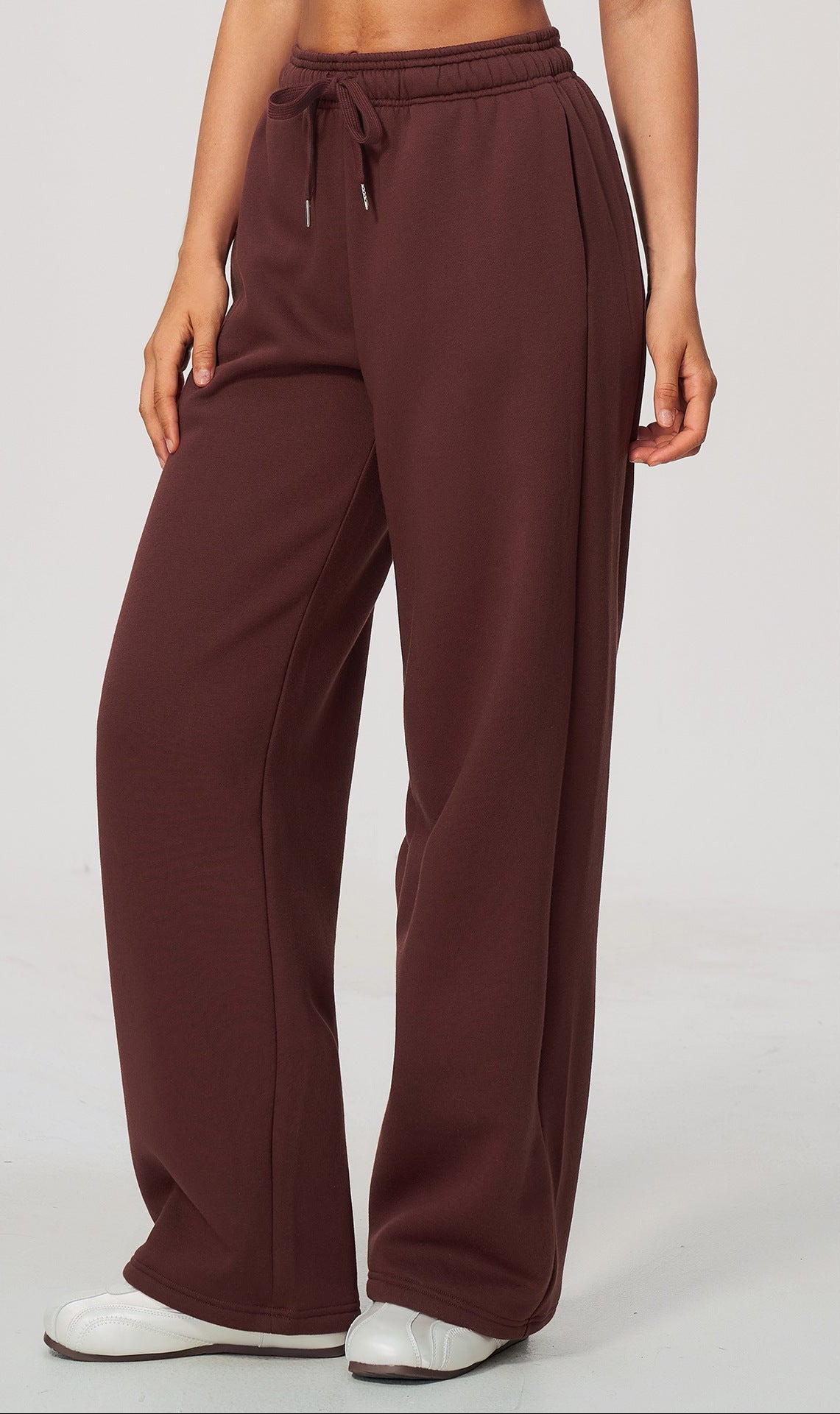 Burgundy high-waisted sweatpants with elastic waistband and drawstring, wide legs