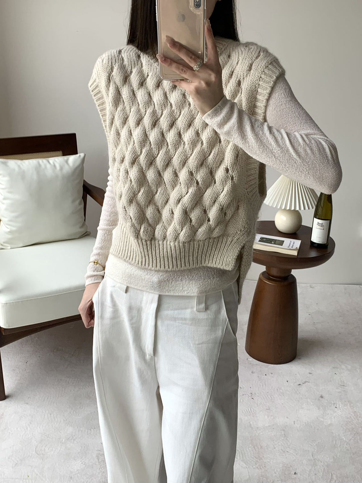 Cream chunky cable-knit sweater vest with sleeveless crew neck and ribbed hem