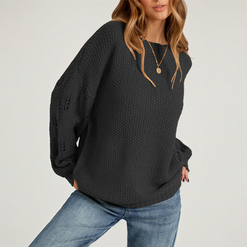 Black open-stitch sweater with loose sleeves and crew neckline