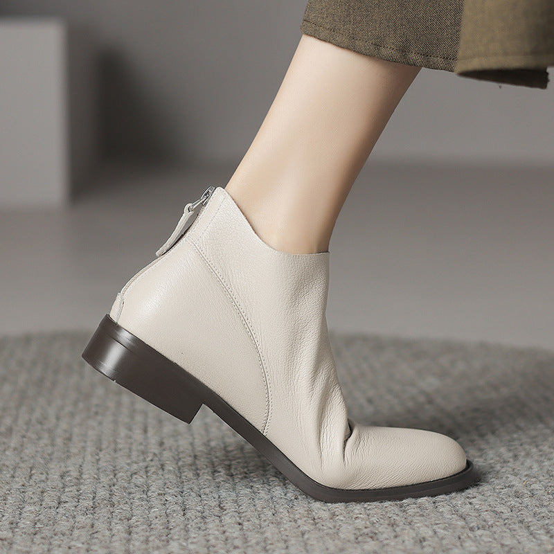 Women’s light off-white short ankle boots with thick heel and smooth leather look.