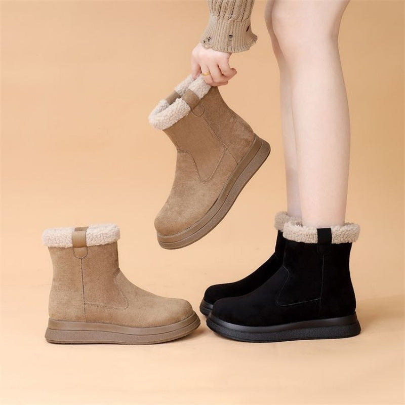 Tan and black fleece-lined short boots with fuzzy cuffs and thick tread soles