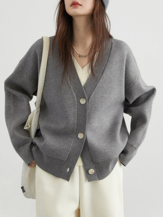 Gray V-neck cardigan sweater with button front, ribbed hem, and long sleeves