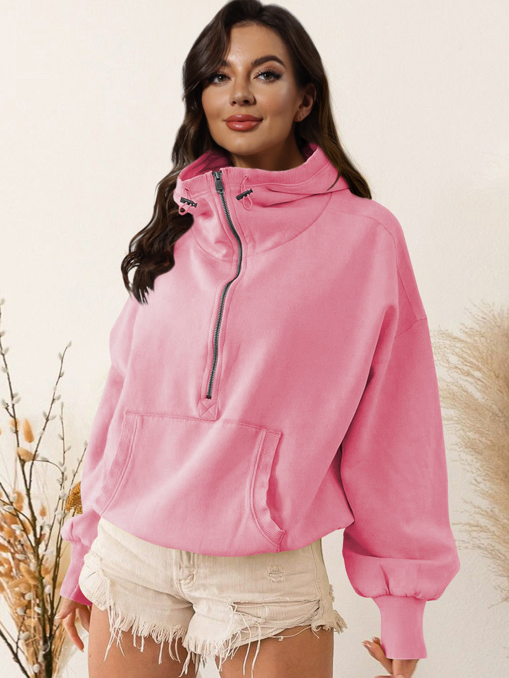 Light pink hooded zip sweatshirt with drawstring and front kangaroo pocket