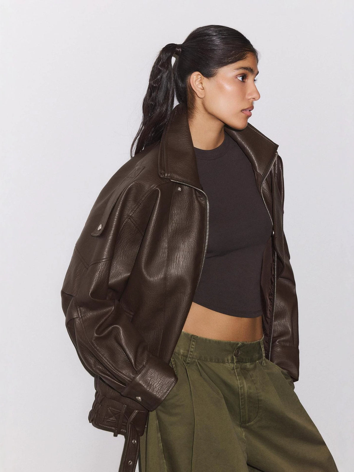 Brown leather biker jacket, stand collar, front zip, side pockets, slightly cropped loose fit