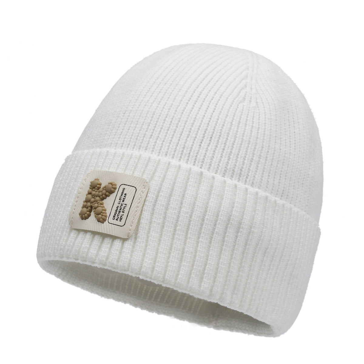 White rib-knit beanie hat with pom-pom style patch on cuff