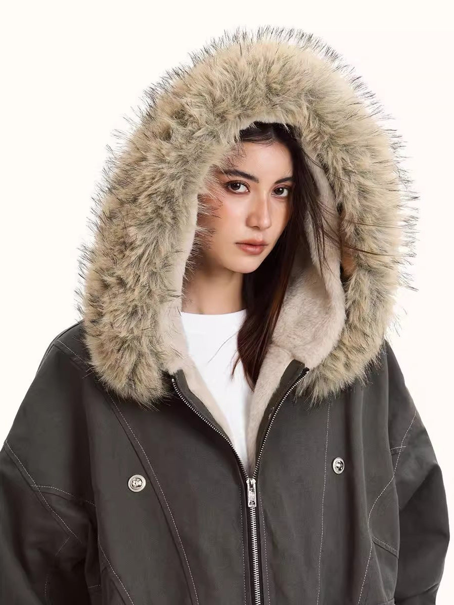 Close-up of dark hooded jacket with beige faux fur hood trim and full-length zipper