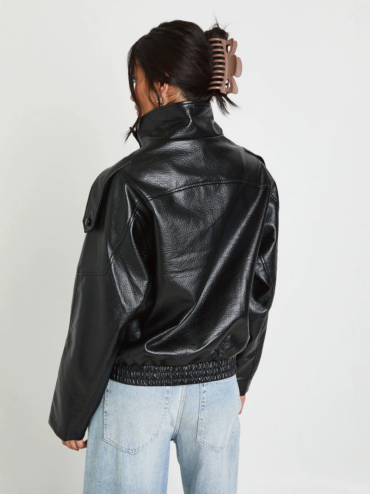 Black PU leather stand-up collar jacket, back view with seam panels.