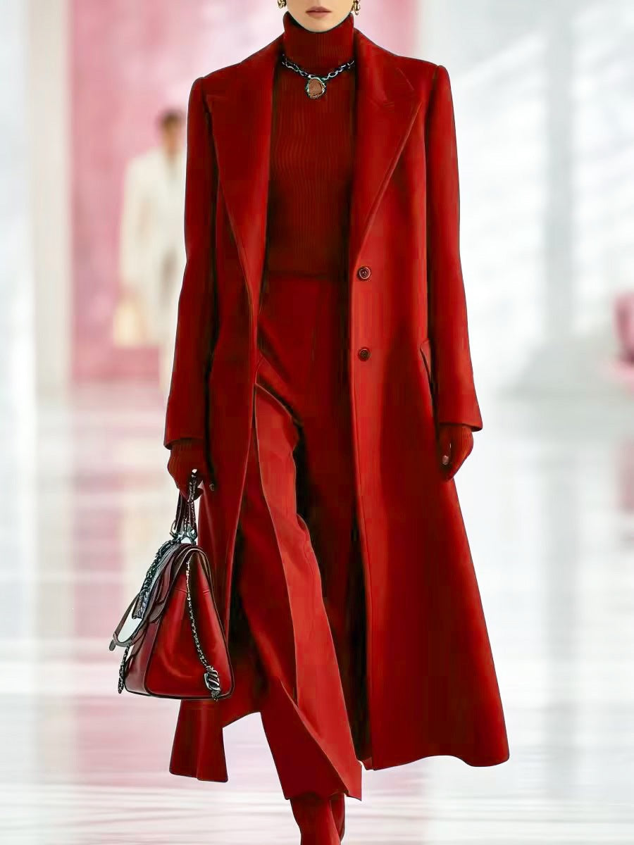 Red long tailored coat with peak lapels, two buttons, and a slim silhouette