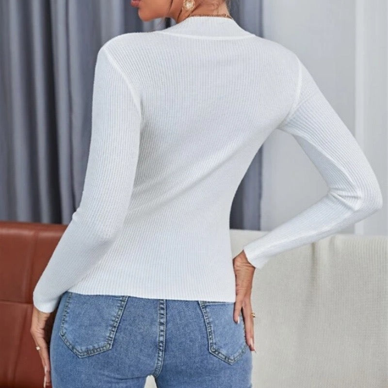 White mock neck ribbed knit long-sleeve top, back view with curved hem.