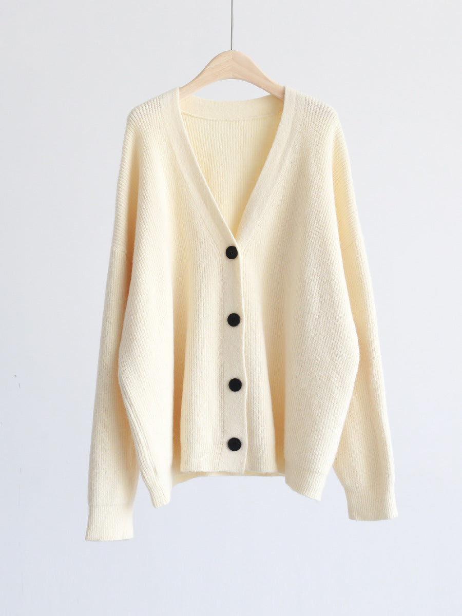 Cream V-neck mohair cardigan on hanger, button front and long sleeves