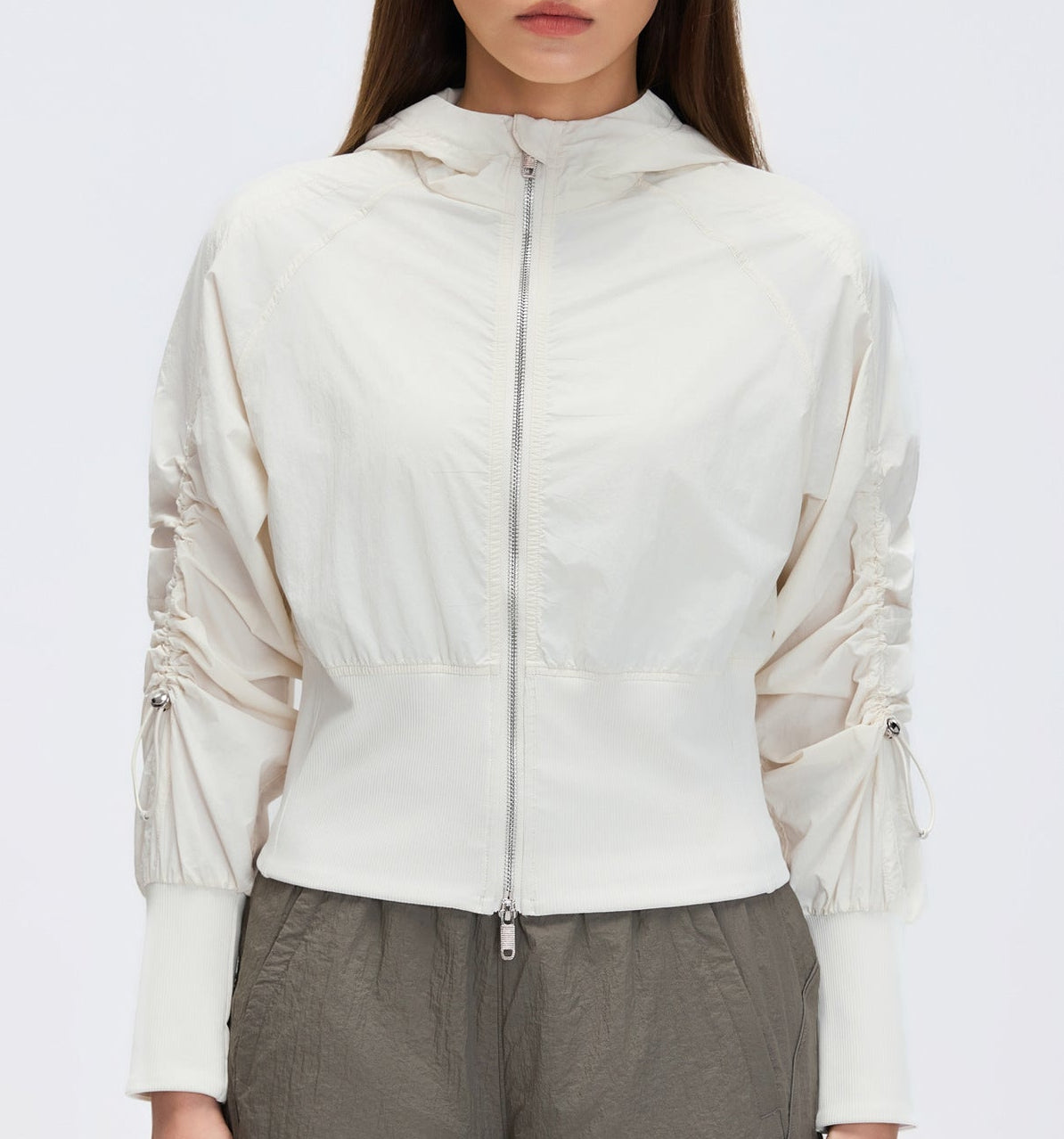 White cropped hooded zip-up windbreaker with elastic cuffs and front zipper