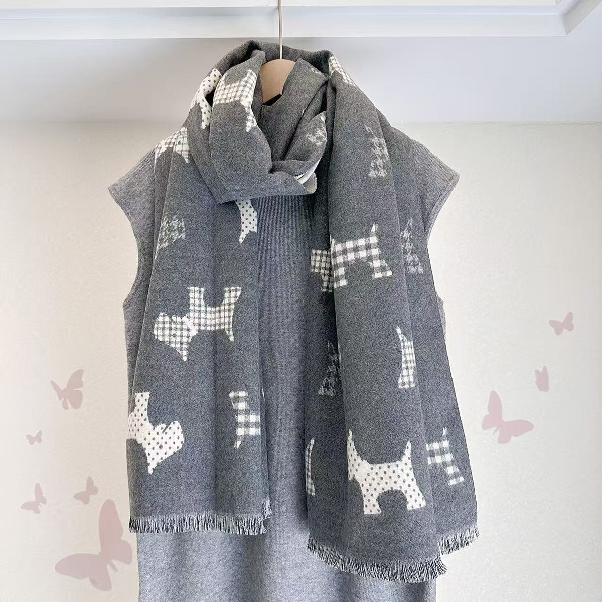 Gray scarf with dog motifs and fringed ends, draped around the neck