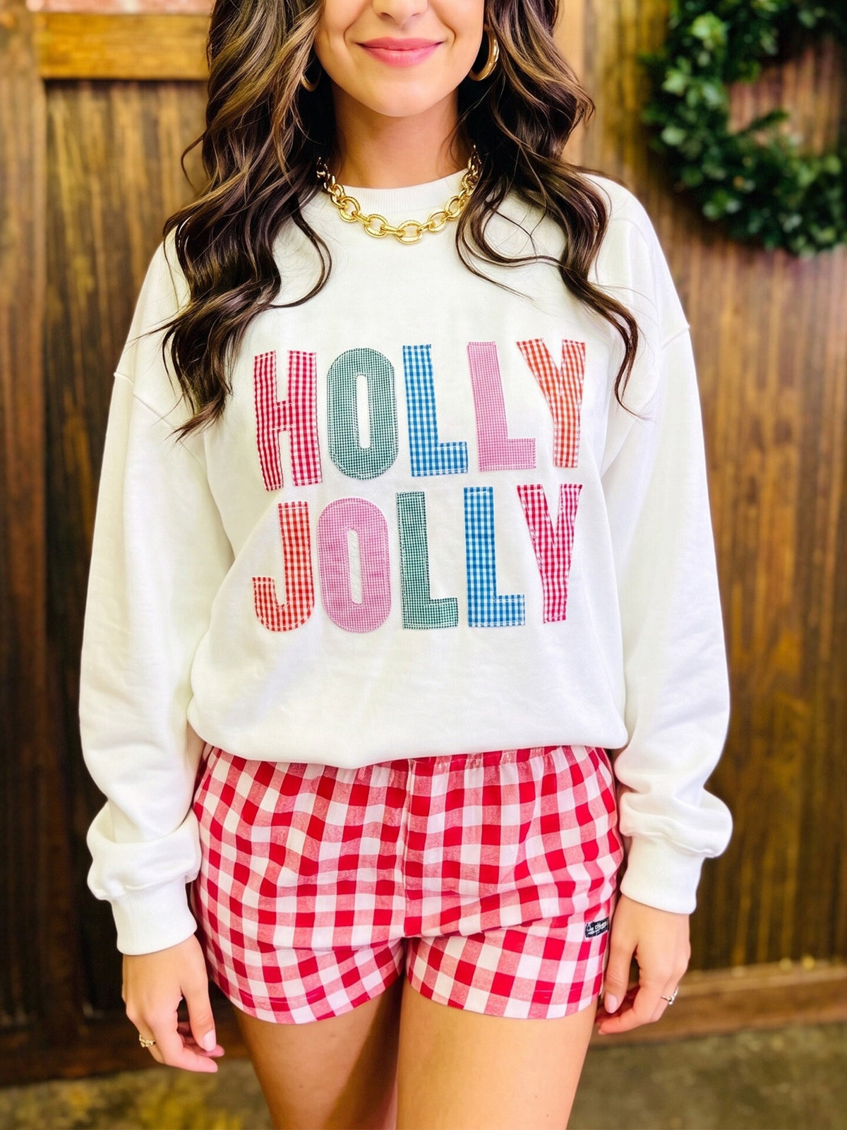 White long-sleeve sweatshirt with HOLLY JOLLY appliqué lettering