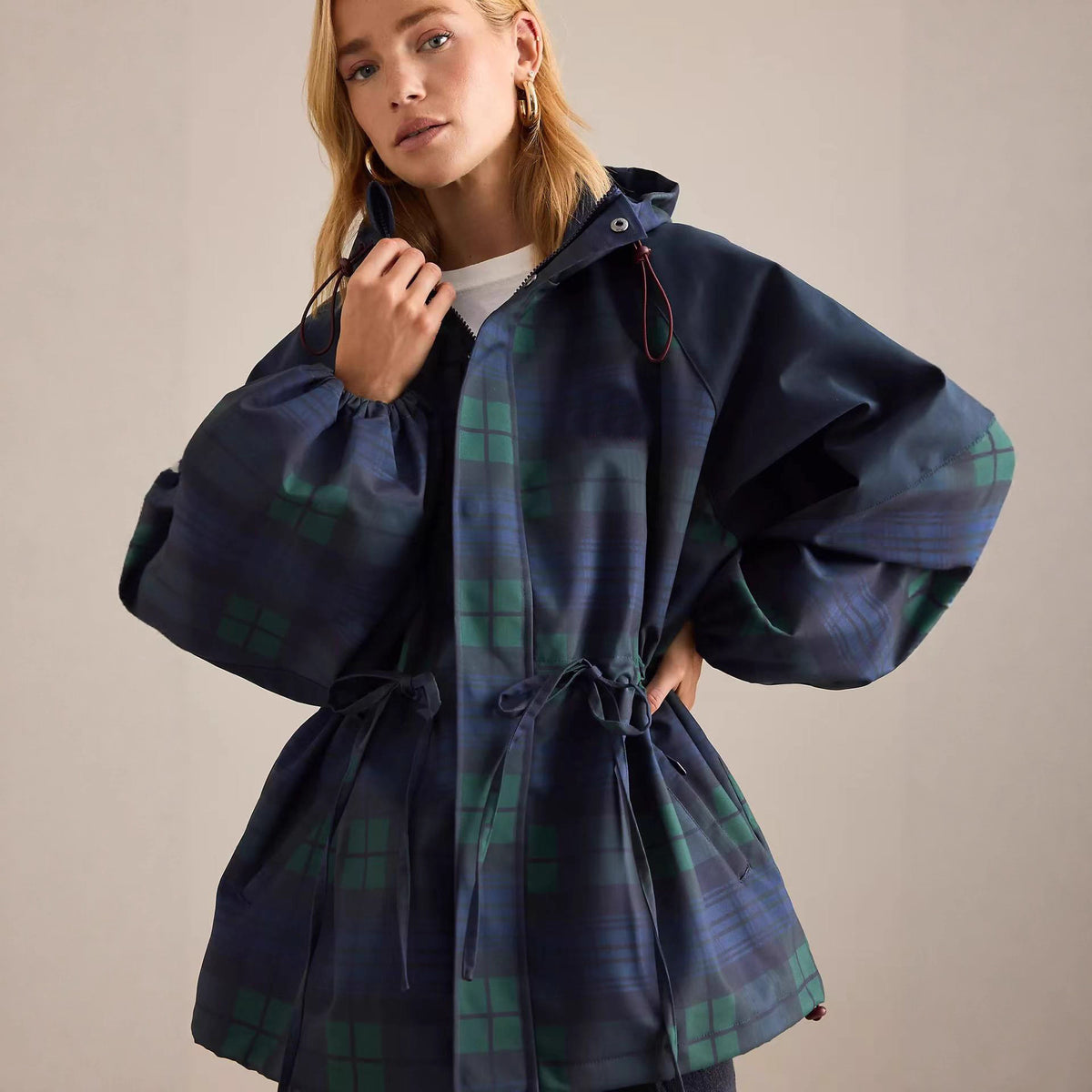 Dark blue short windbreaker with stand collar, hood, and green plaid drawstring waist