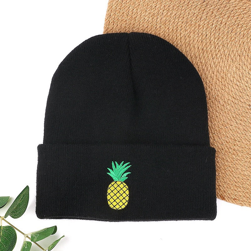 Black knit beanie with green pineapple embroidery