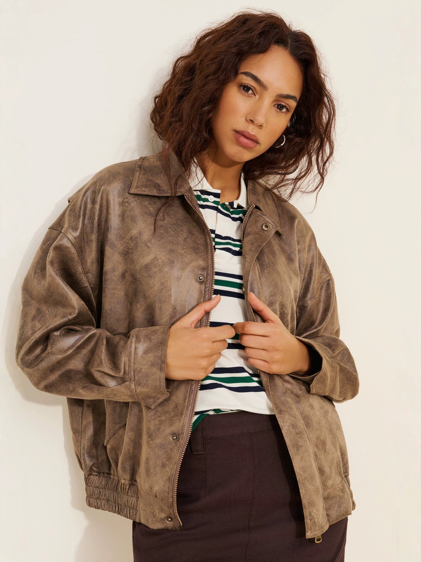 Women’s distressed brown faux leather bomber jacket with snap front and stand collar