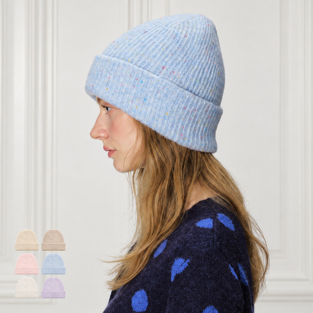 Blue speckled rib-knit beanie with a wide folded cuff, shown in profile.