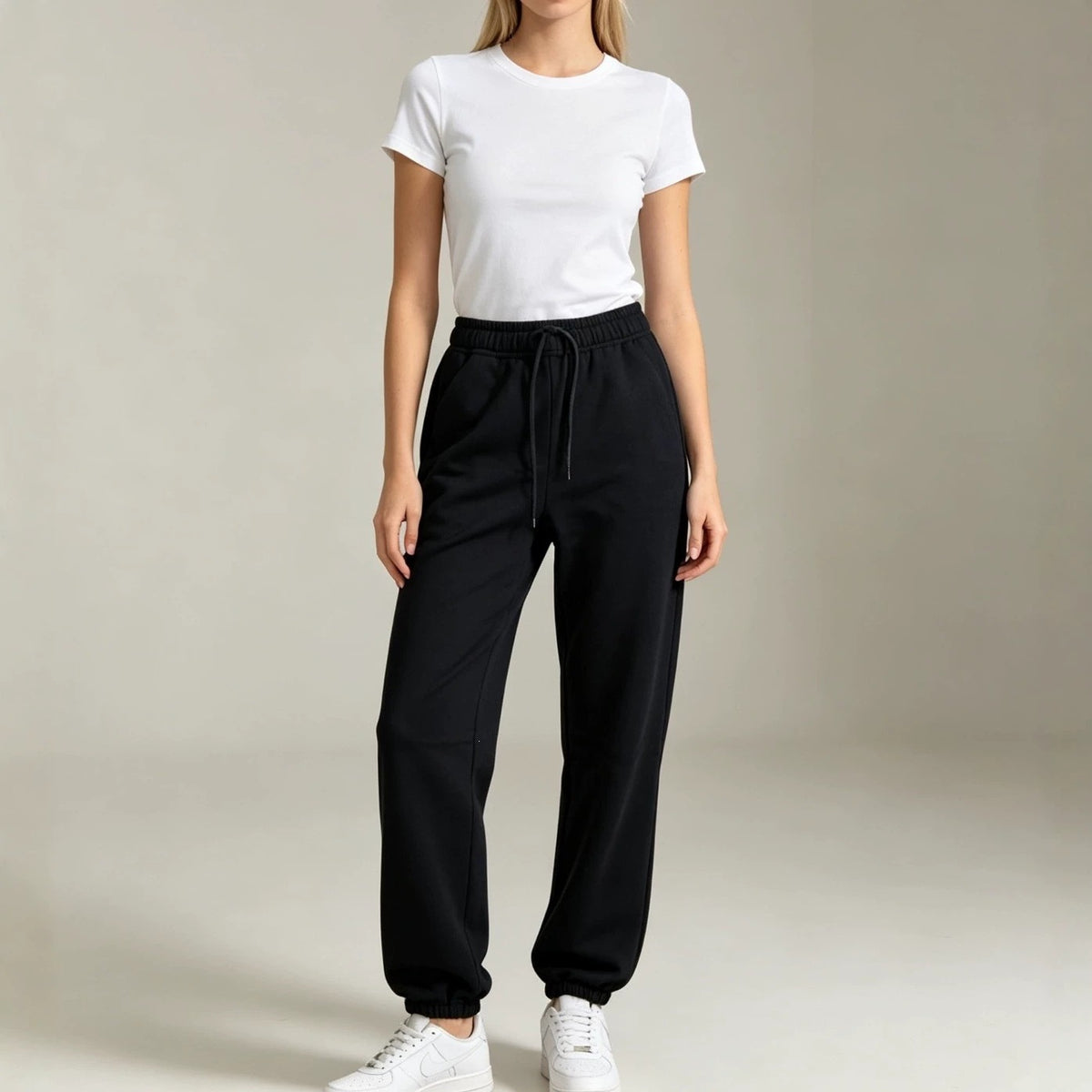 Black fleece jogger sweatpants with elastic waistband and relaxed tapered legs