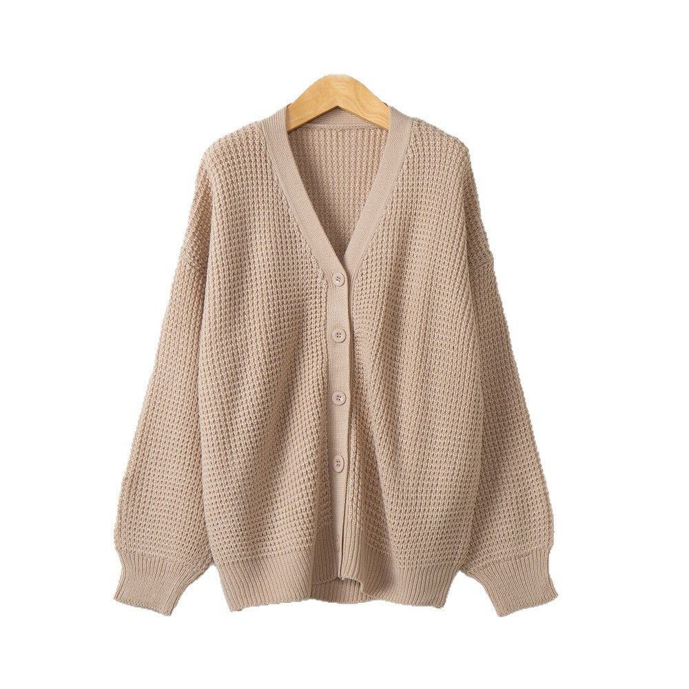 Beige knit cardigan sweater with V-neck and button placket, long sleeves, ribbed hem