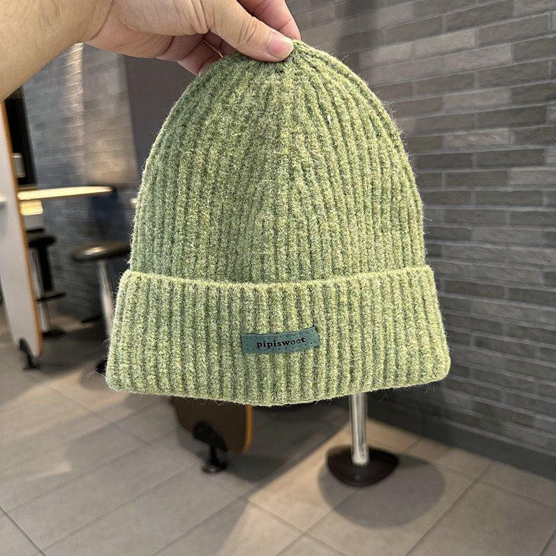 Green ribbed knit beanie hat with cuff brim and pipiswoot logo patch