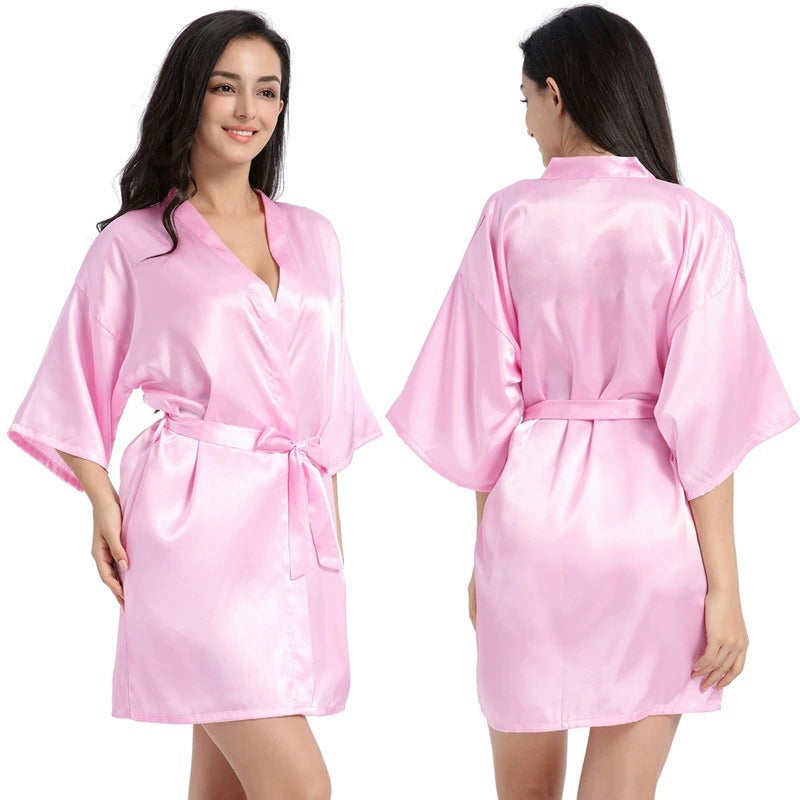 Pink satin short robe with V-neck and tied waist belt, half sleeves.