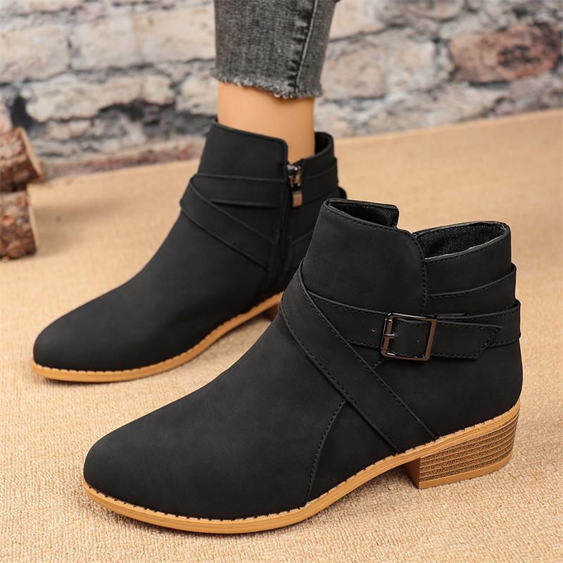 Black Chelsea ankle boots with side zipper, double straps, and block heel.
