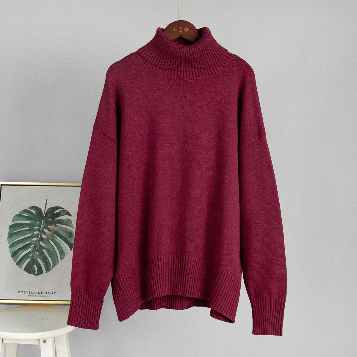Burgundy knit turtleneck pullover sweater with loose fit and ribbed cuffs